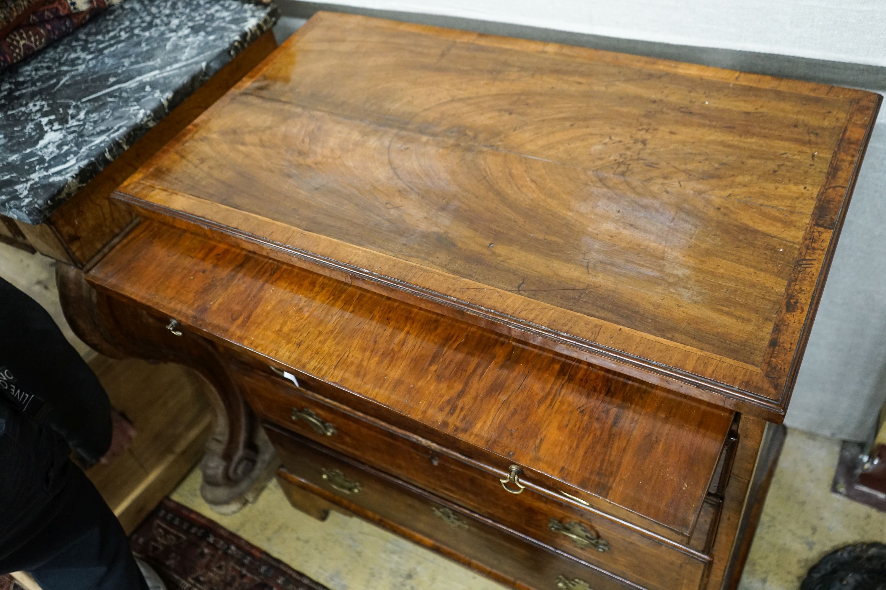 An 18th century and later feather banded walnut chest with slide, width 84cm, depth 49cm, height 86cm